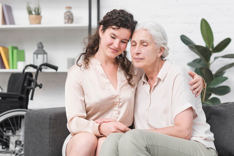 mother-embracing-her-senior-mother-sitting-sofa-home_23-2147861609 mother-embracing-her-senior-mother-sitting-sofa-home_23-2147861609